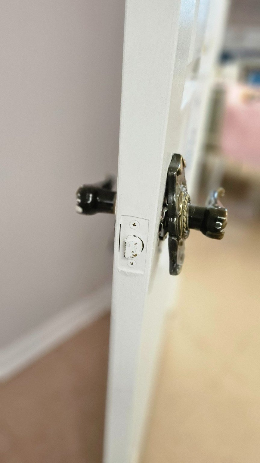 Before — original lock hardware at the door edge